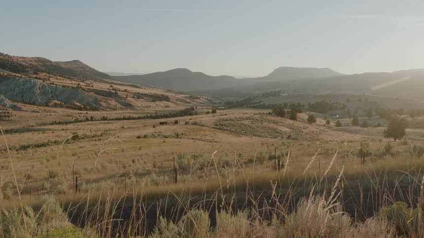 A haze is hanging in the air over a mountain valley during the day
