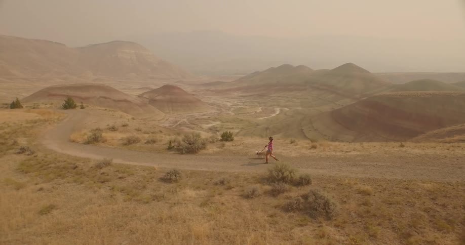 A woman hikes with her dog