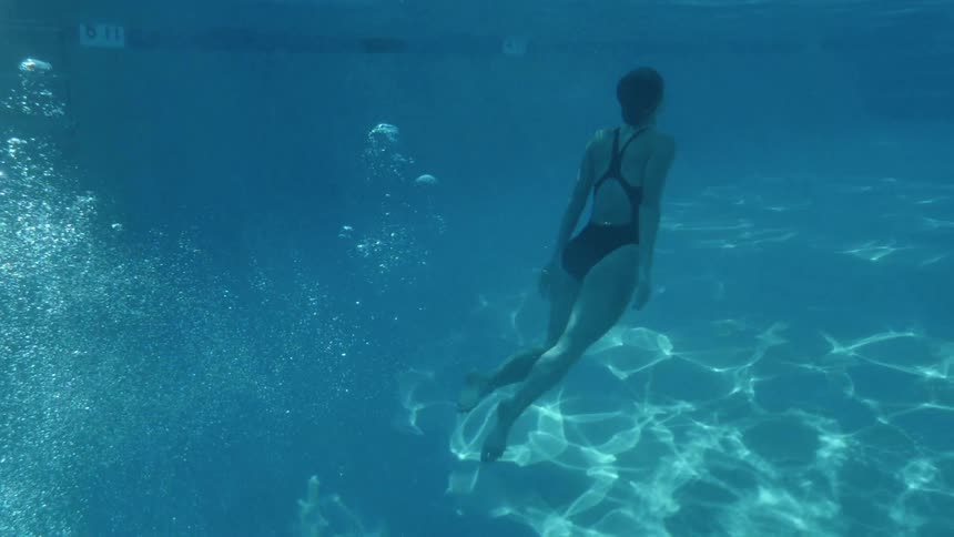 A woman swims in a swimming pool