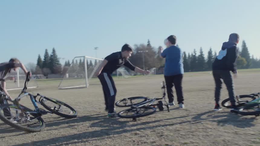 A group of kids play soccer on a field