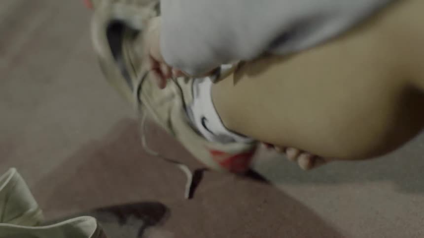 Woman putting on her cleats