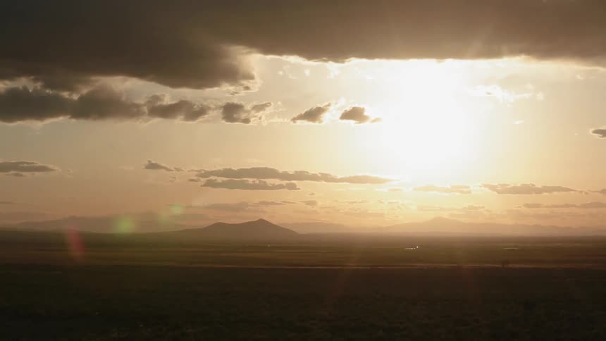 The sun is setting over this vast field
