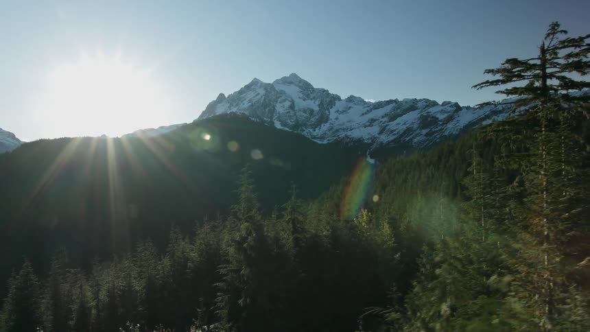 The sun is shining over the top of the mountains