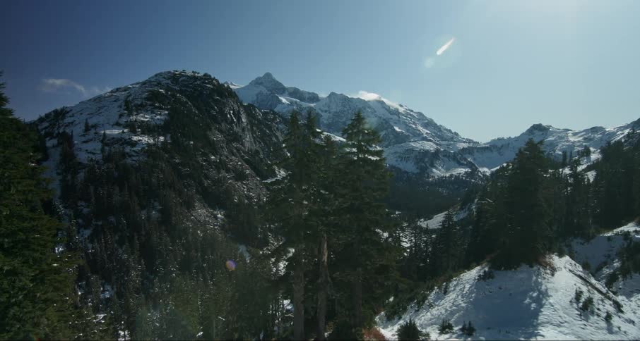 The mountains are covered with snow on a sunny day