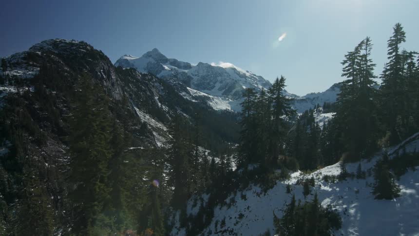 Snow and trees cover the mountain landscape