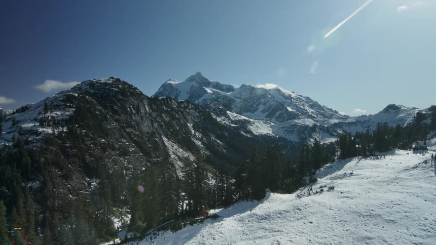 Sunlight is shining on a mountain valley on a winter day