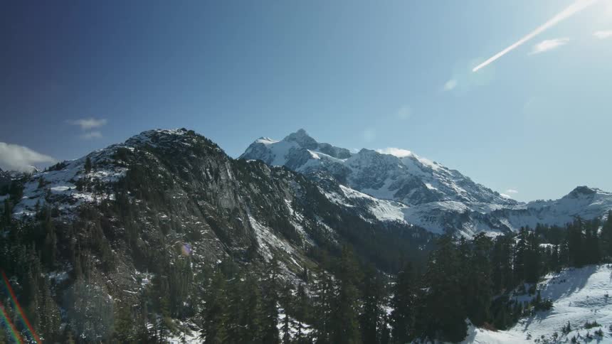 Sunlight is shining on a mountain valley on a winter day