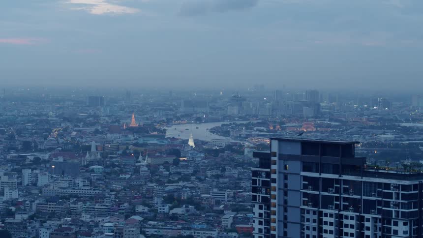 Buildings stand in a city at sunset