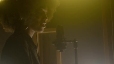 A woman sings into a microphone