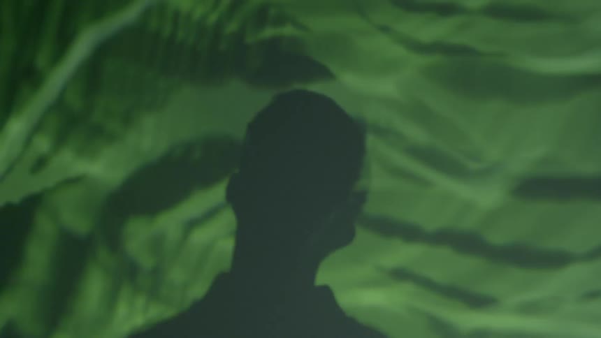 Man looks at a wavy substance
