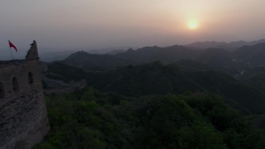 The sun shines on a stone wall stretching across mountains