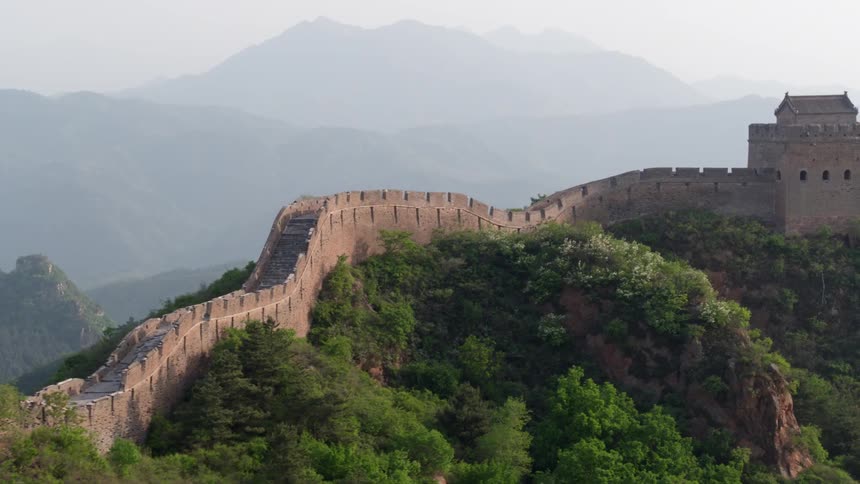 A wall stretches across a tall mountain