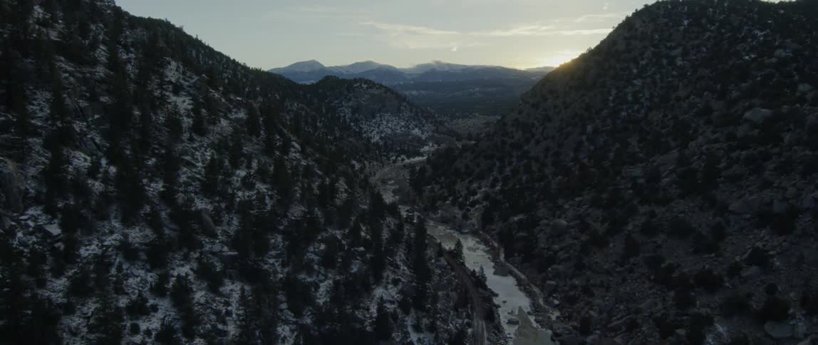 A small stream runs through this valley in the shadows