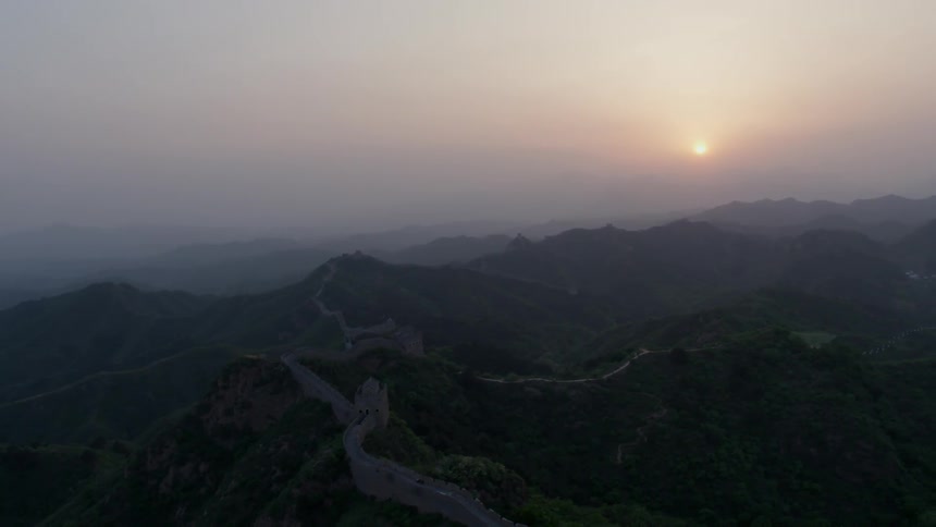 The sun sets over the great wall of china