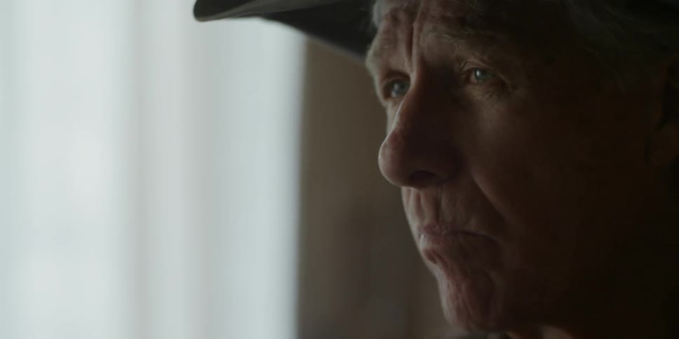 A man in a cowboy hat spoons food into his mouth