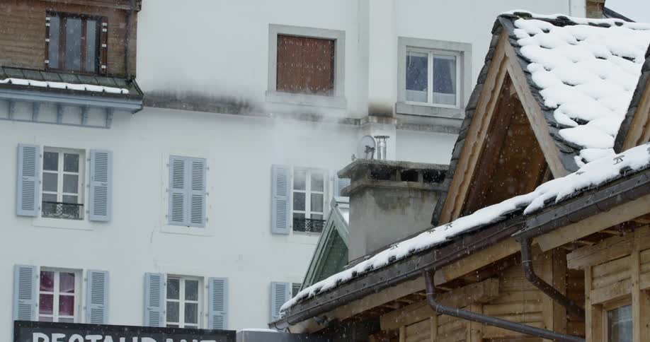 The snow slowly falls over the buildings