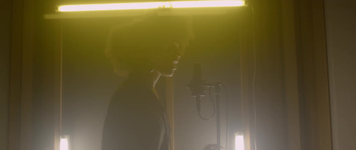 A woman records in a vocal studio
