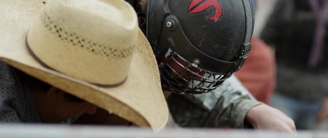 A bull rider prepares to ride a bull