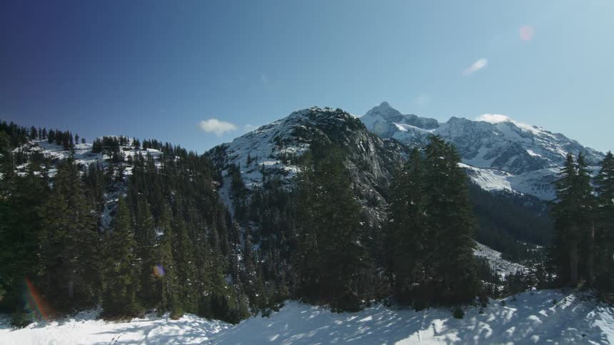 The cliff is covered with snow on a sunny day