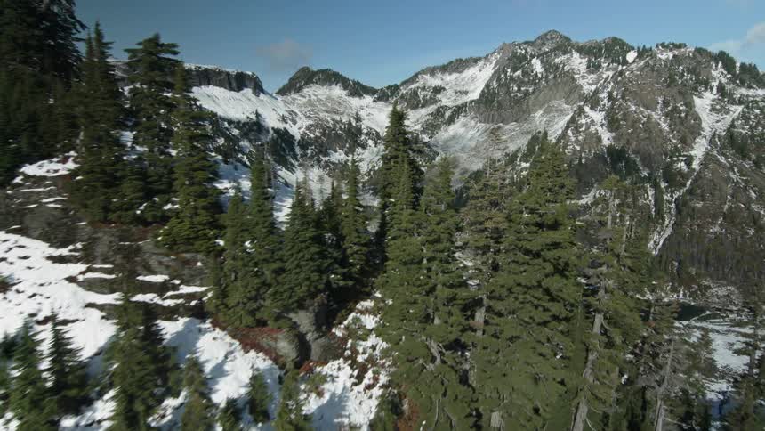 A small body of water lines the bottom of the mountain below