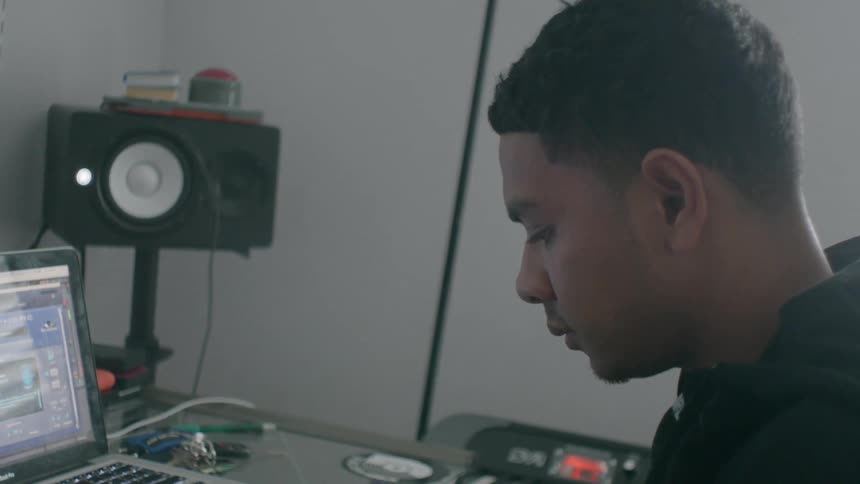 A man nods his head as he works on his computer
