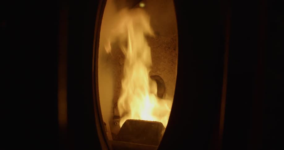 The fire is flaming inside of the furnace
