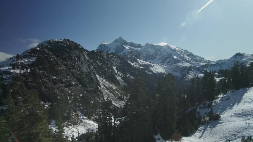 Sunlight is shining on a mountain valley on a winter day