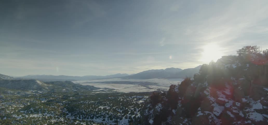 The sun shines on a snowy mountain