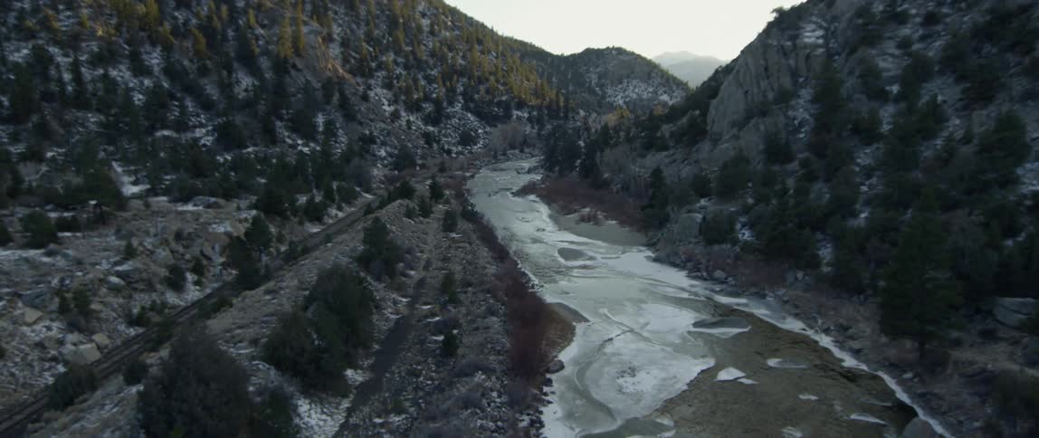 An icy river flows through mountains