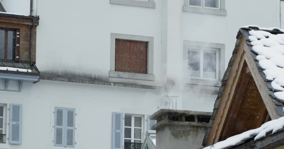 Snow is falling in front of this building