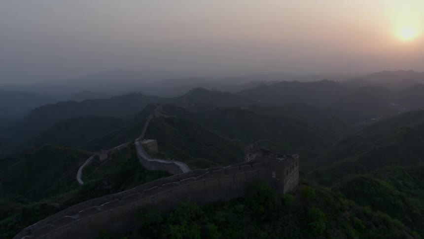 The sun sets over the great wall of china
