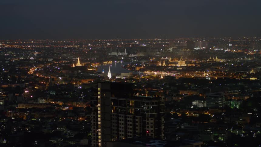 City buildings and lights illuminate the night sky