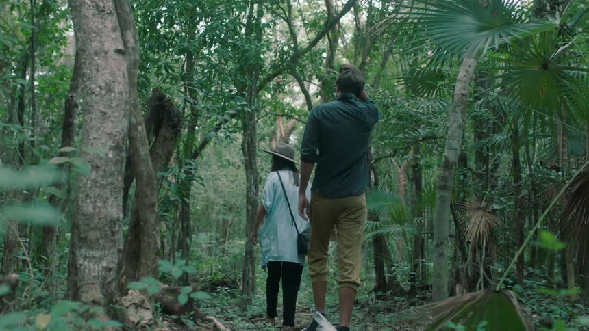 Man and woman walk in the woods
