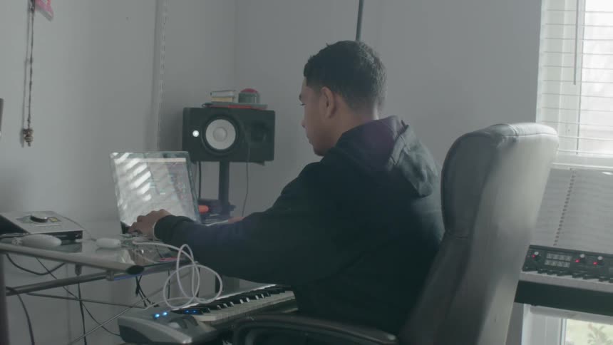 Man works on a laptop near the window