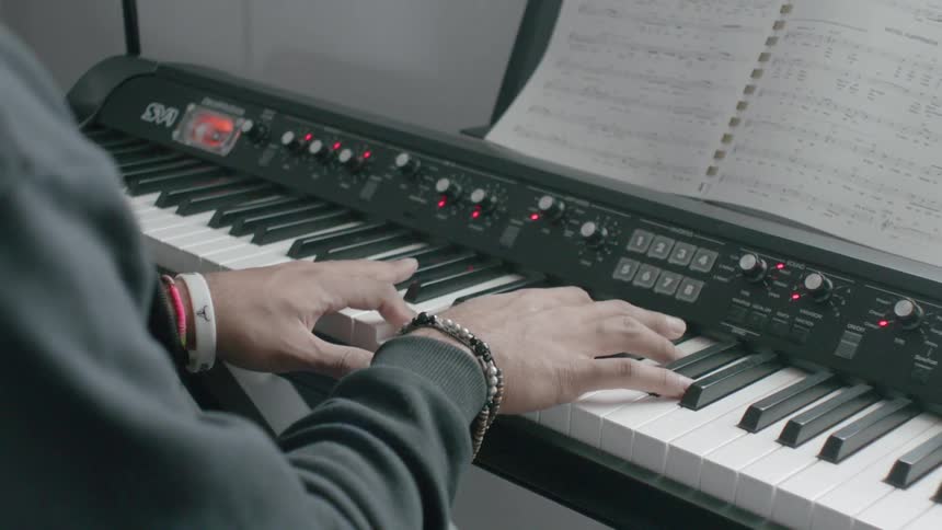 A person slowly plays the keys on a keyboard