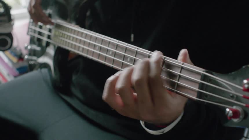 A person is slowly playing a guitar