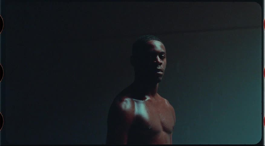 A man turns his head in the dark room