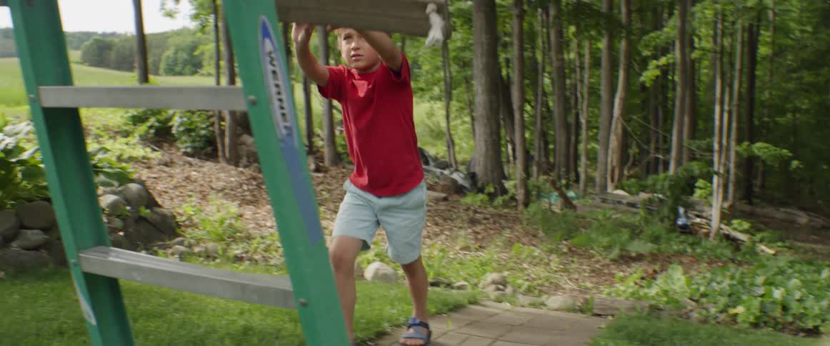 A child pushes a swing towards a ladder