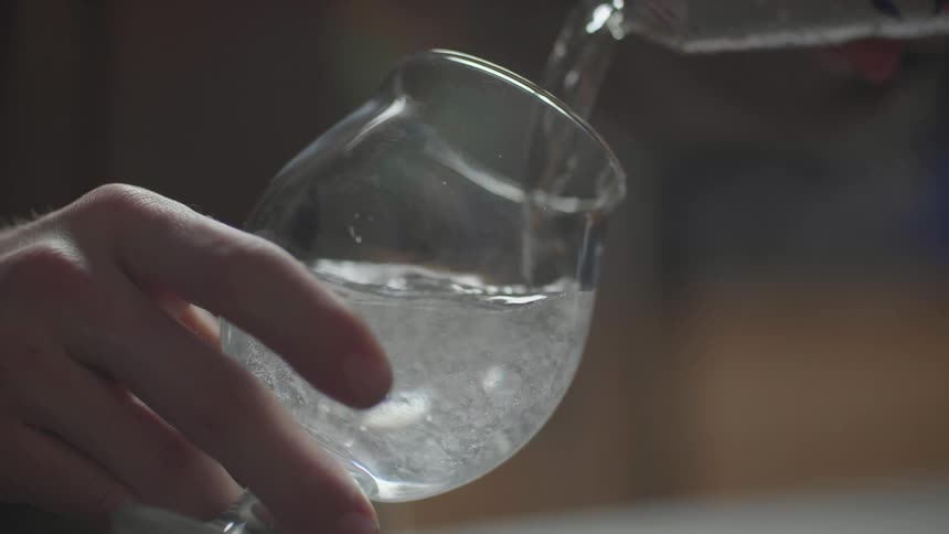 Seltzer water is poured into a glass