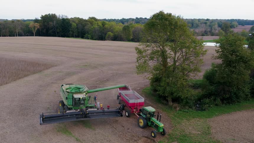 People walking around farm equipment
