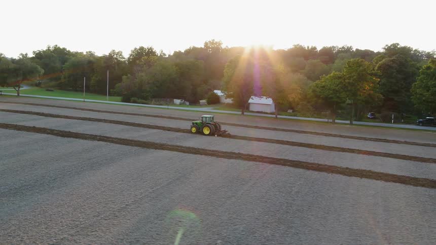 The tractor is working the field having already created three lines