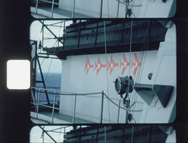 Wind blows the ropes and lines on an aircraft carrier at sea