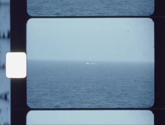 Submarine breaches the ocean surface and water splashes up