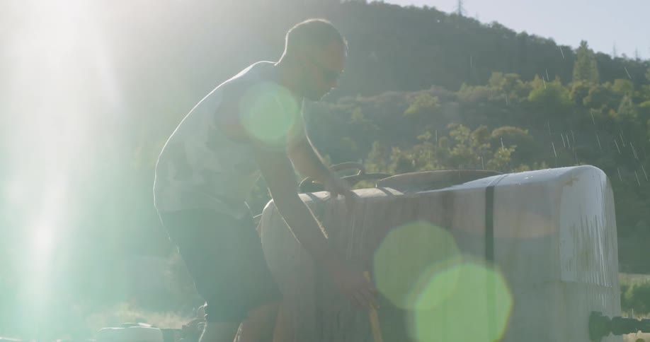 Man fills a container with a hose