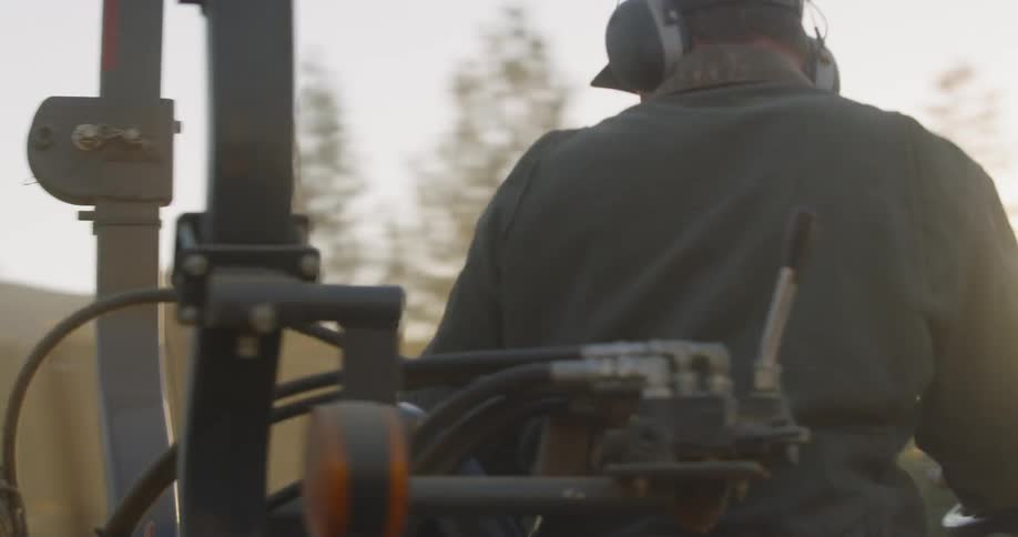 A man drives a vehicle that is spraying the fields