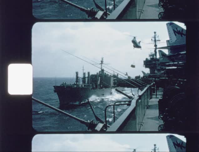 Helicopter flies over a ship in the ocean