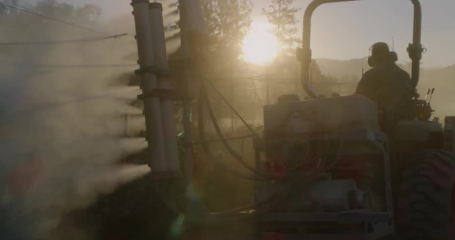 A man is working the farm in a vehicle