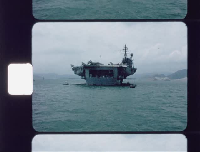 Aircraft carrier is floating in the water with planes on top