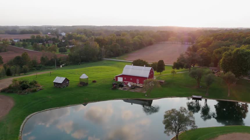 The pond near the farm has reflective calm water