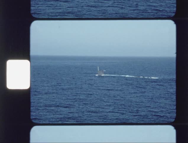 A submarine slowly descends below the water